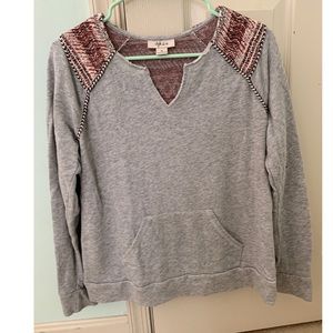 Grey and patterned sweatshirt